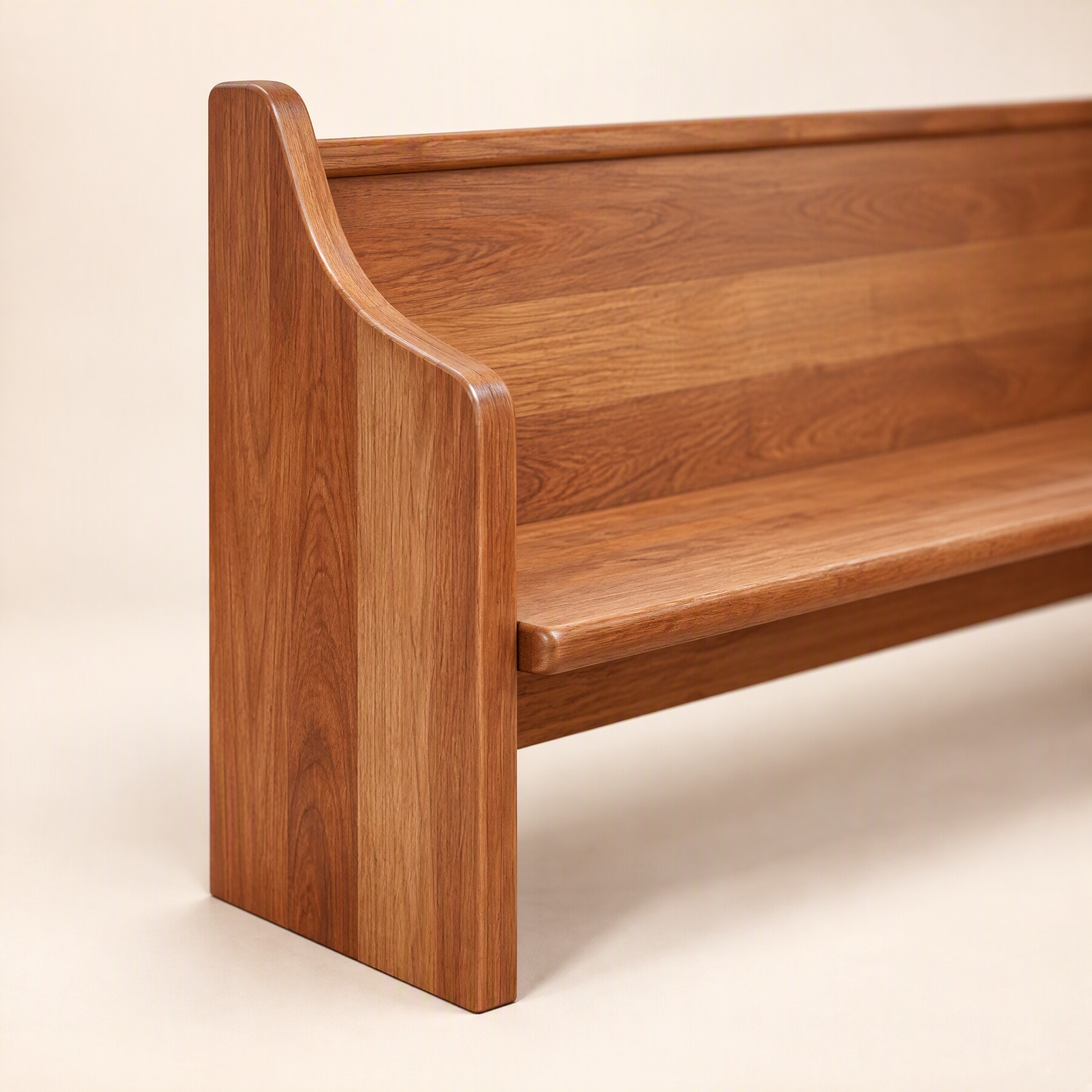 Close-up of a pew's curved end panel, the seat and back running into it