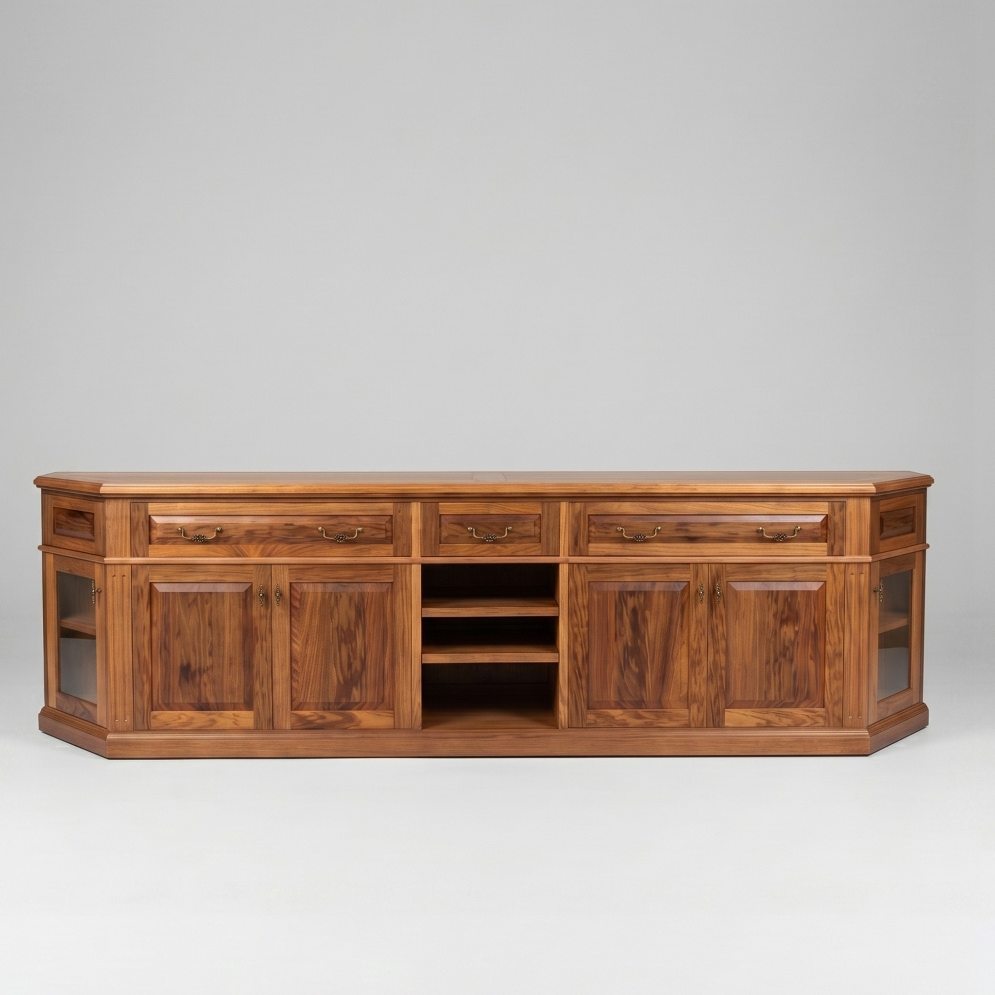 A long Tasmanian Blackwood sideboard with raised-panel doors, brass drop handles, open centre shelves and glass end doors