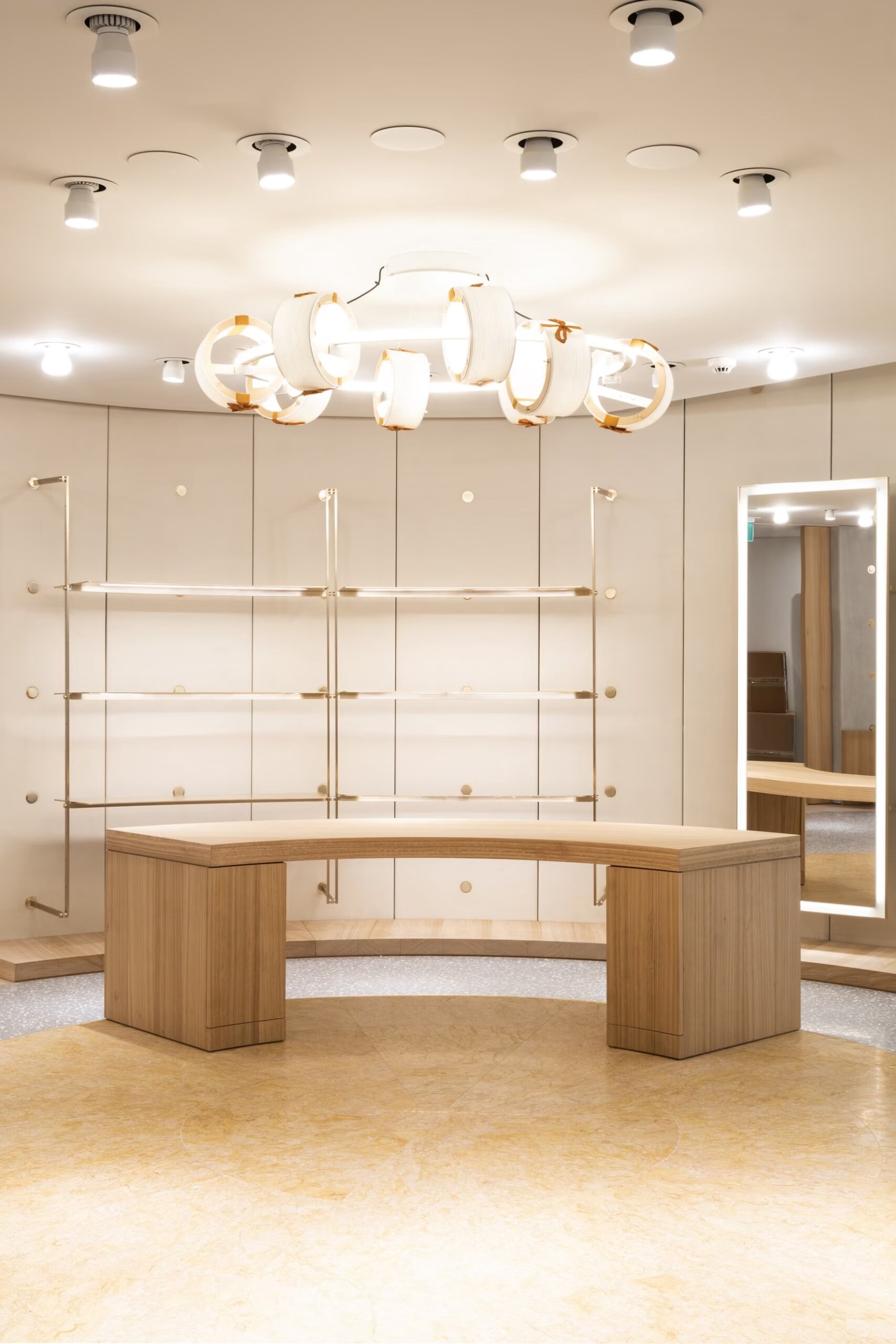 Valentino boutique room with a curved timber counter and wall rails