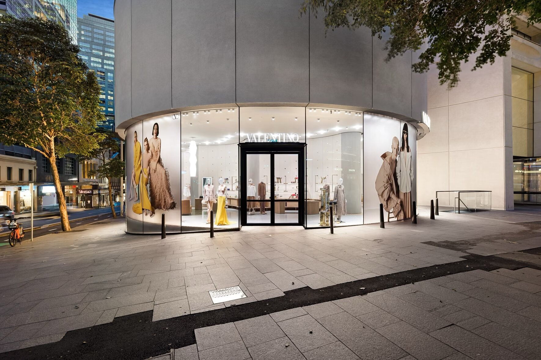 Valentino boutique's round glazed street front at dusk