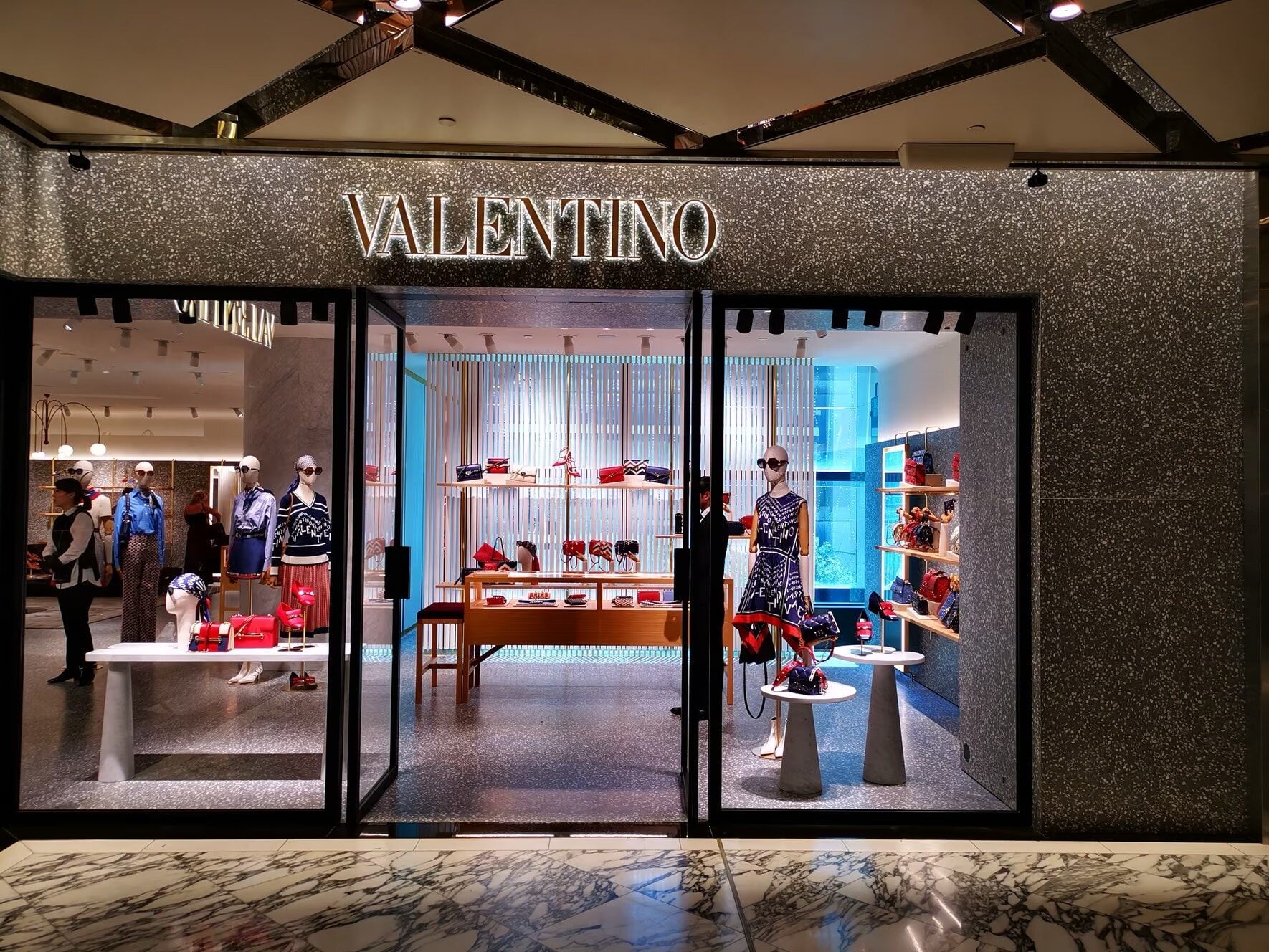 Valentino shopfront with a sparkling stone fascia and glass doors