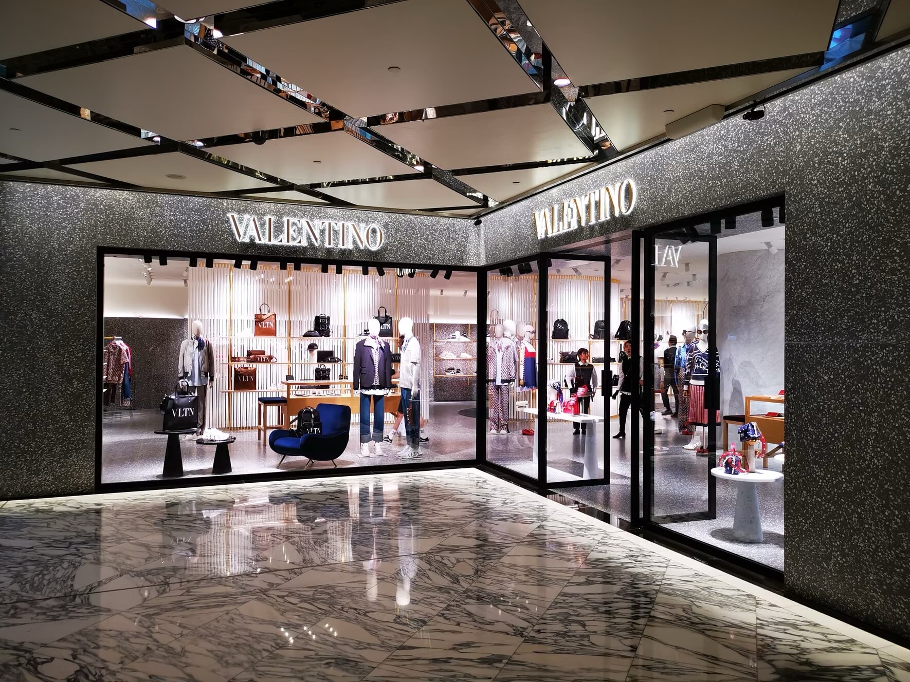 Valentino corner shopfront under a mirrored ceiling