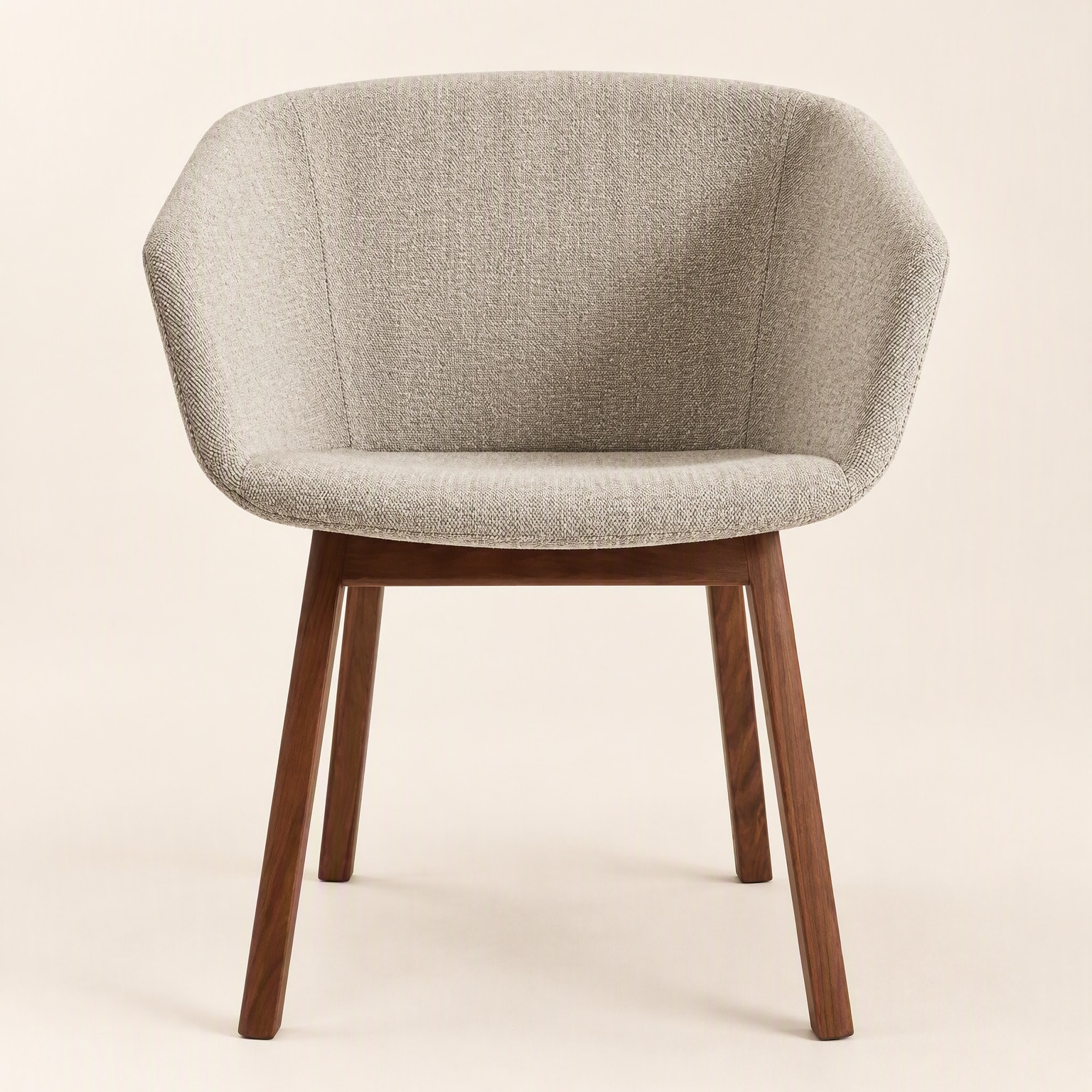 A tub chair upholstered in grey bouclé on four timber legs